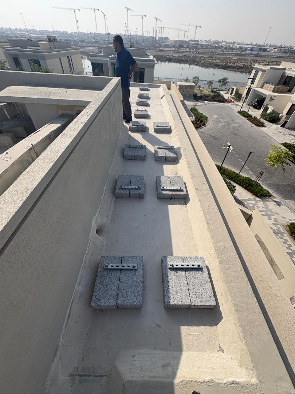 Engineer inspecting a completed villa roof waterproofing in Dubai